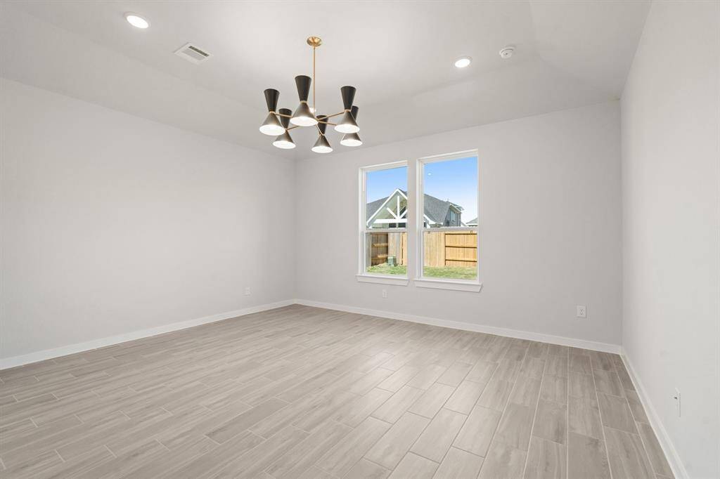 Main bedroom features an elegant chandelier with high ceilings.