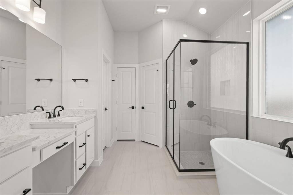 A sleek and modern bathroom vanity with a polished countertop and ample storage space, perfect for organizing essentials. The design combines clean lines with stylish fixtures, creating a functional and elegant focal point for the bathroom.