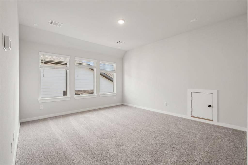 Next to the media room is a bright game room, filled with natural light streaming through large windows. This space is perfect for table games, pool table, or simply relaxing while enjoying the open, airy atmosphere.