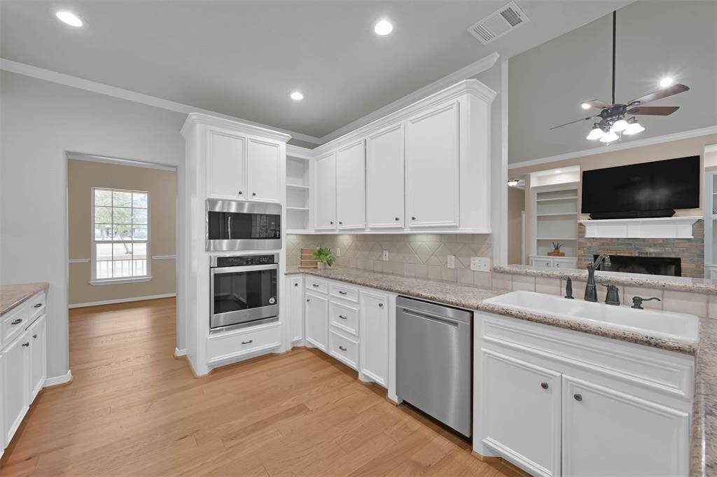 Kitchen has lots of custom cabinets and recently replaced stainless appliances. Kitchen opens to Formal Dining
