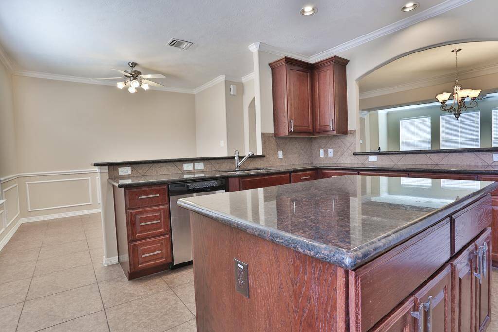 opposite view of kitchen looking over at the bar and breakfast room
