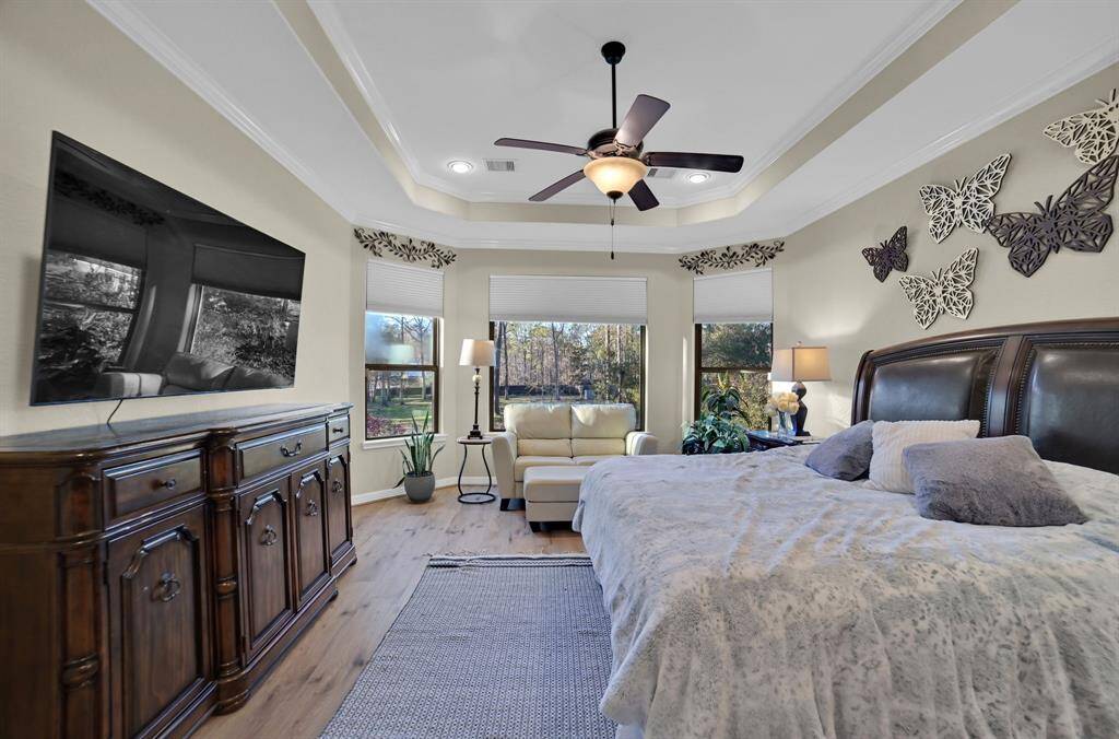 Another angle looking through the elegant and spacious primary retreat with luxury vinyl plank floors.