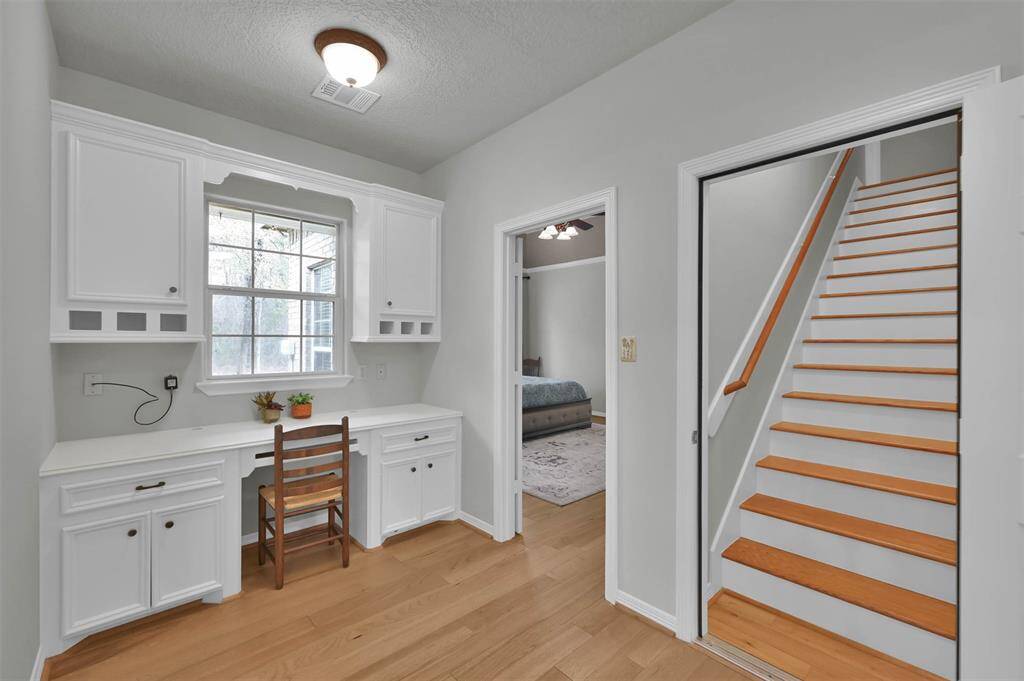 Stylish office/study area with custom cabinetry for ample storage.