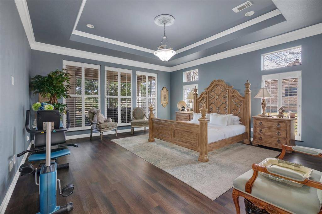 Spacious Primary bedroom with beautiful crown molding around the Cove ceiling,
