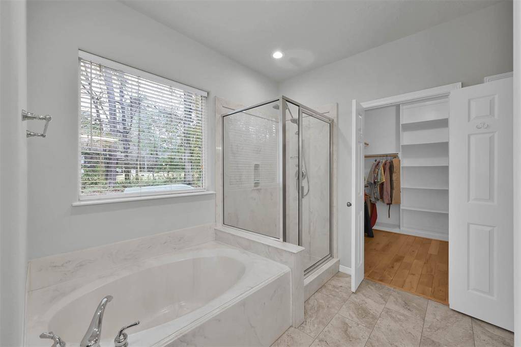 Spacious primary bath with separate tub and shower.