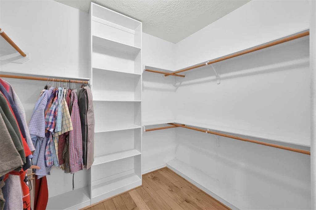 Custom shelving enhances the primary bedroom closet for optimal organization.