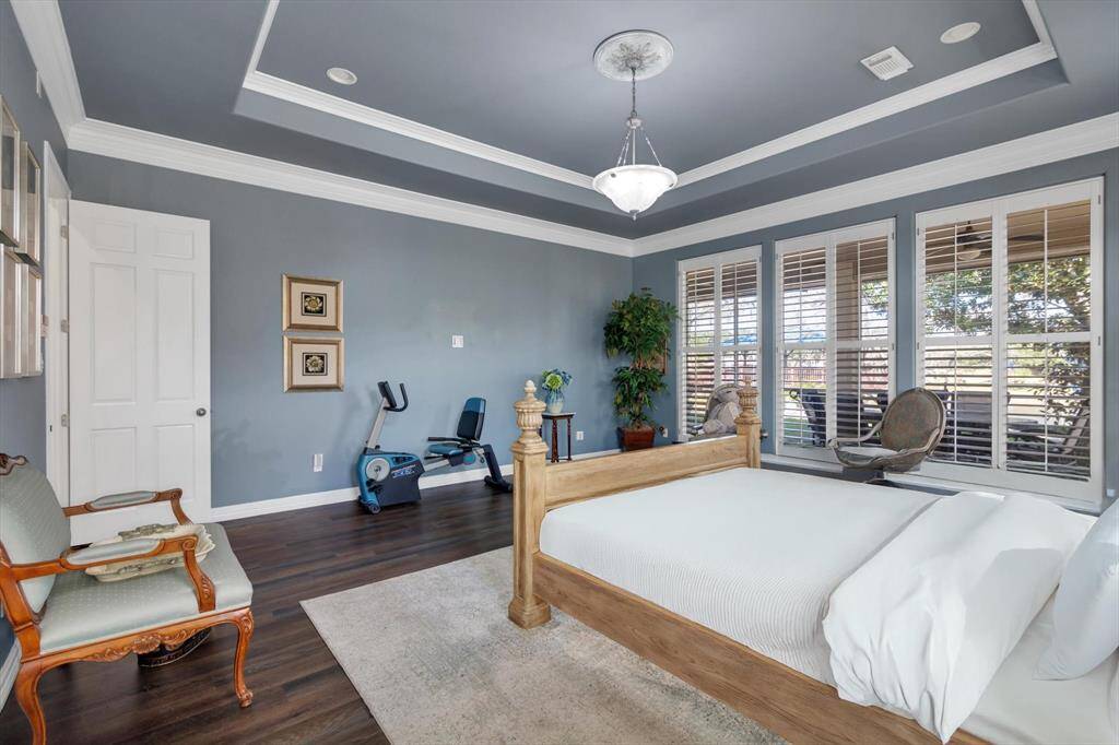 Primary bedroom has windows across the back with view of river