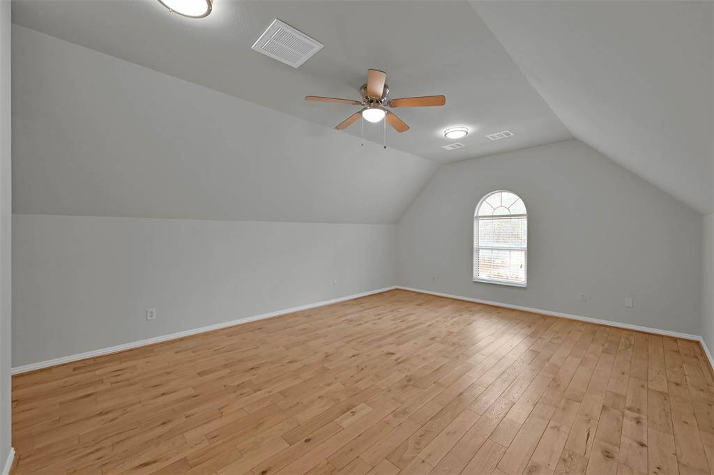 Upstairs flex room ideal for a game room or extra bedroom, complete with a convenient half bath.
