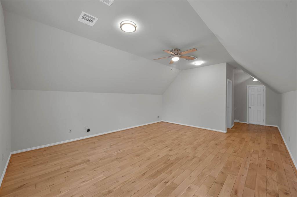 another view of the upstairs flex room- ideal for a game room or extra bedroom, complete with a convenient half bath.