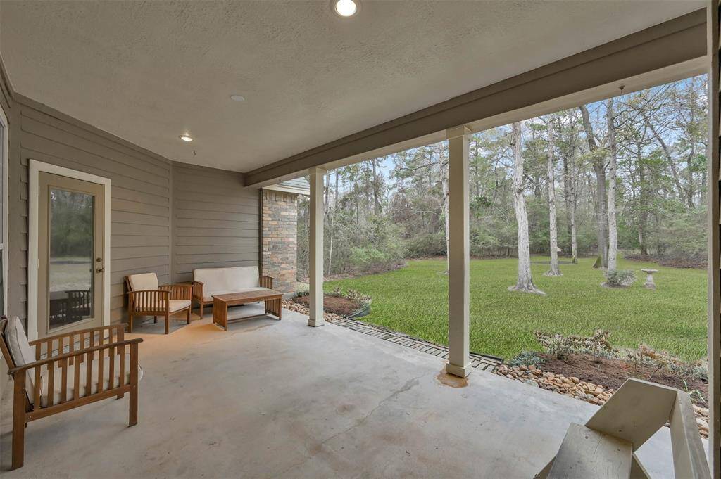 Spacious wrap-around patio with stunning views of the lush acreage and abundant wildlife.