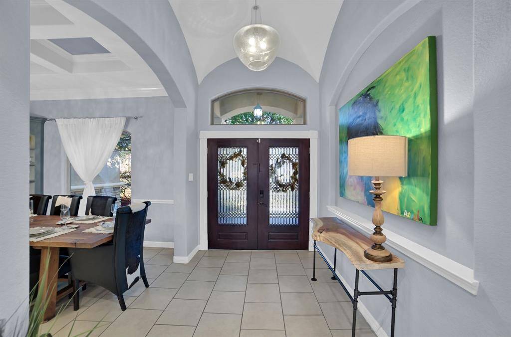 The tasteful foyer opens to the formal dining and family room.