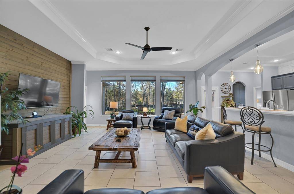 From this view, you can appreciate the sheer size of the living room with beautiful tile floors! This spacious family room can accommodate many furniture arrangements. The family room leads to the magnificently open and spacious kitchen.