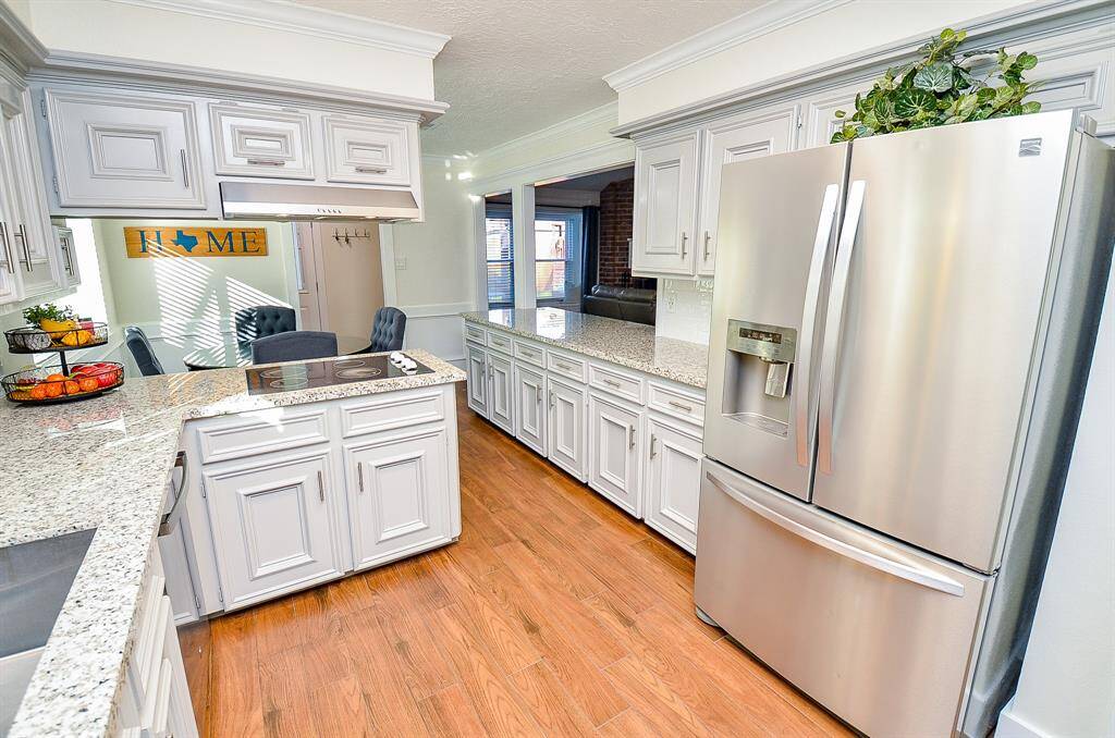 The chef's kitchen has stainless steel appliances.