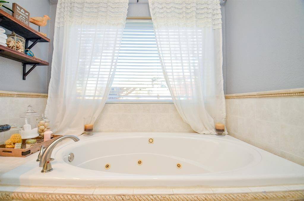 The master bathroom suite features a garden tub.