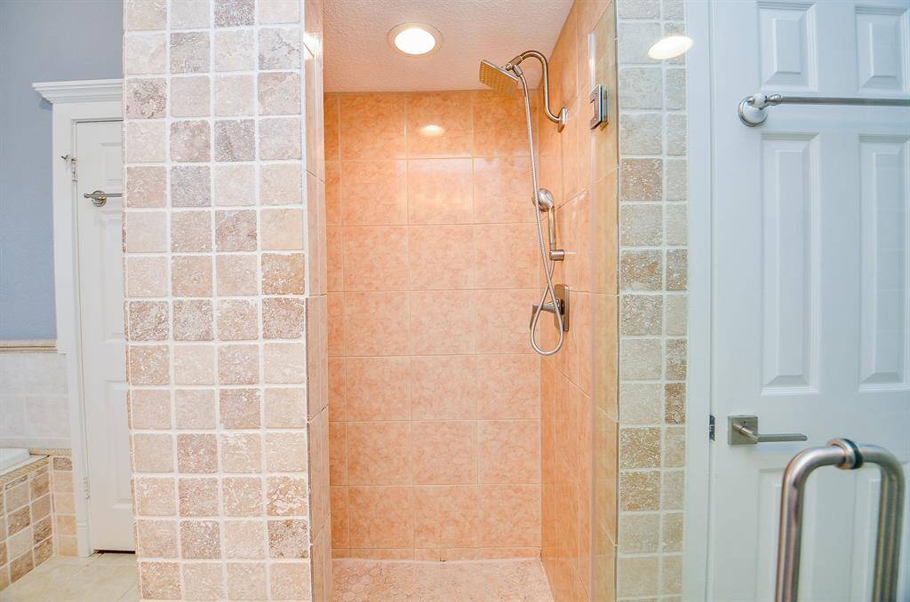 The stand alone shower in the master bath with designer tile.