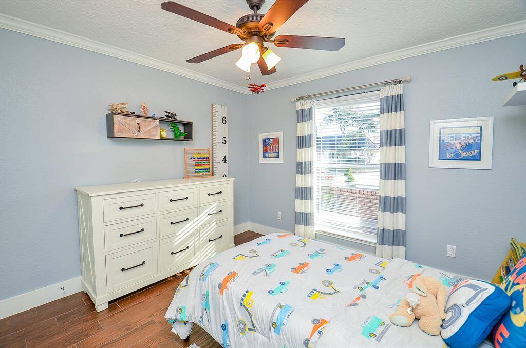 The crown molding adds a special touch to this secondary bedroom.