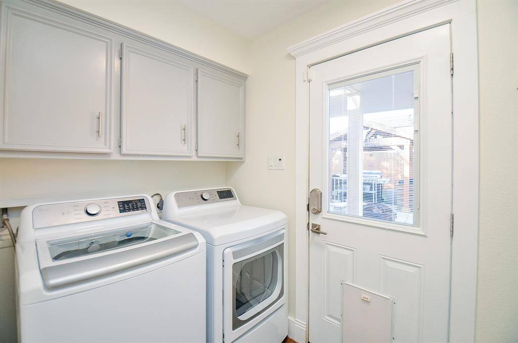 The laundry room has lots of storage with the cabinets.