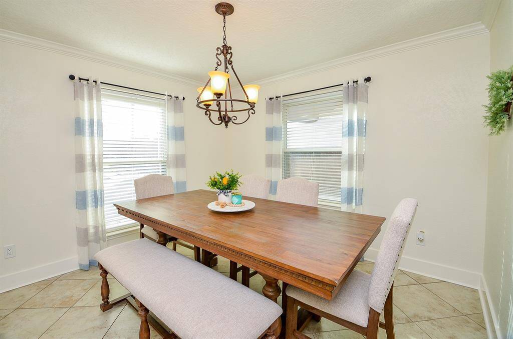 The formal dining room is light & bright with beautiful crown molding.