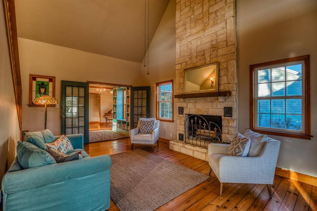 Open concept living w/a timeless limestone fireplace extending to the 2 story ceiling.