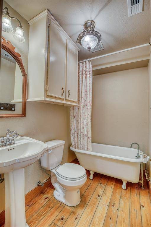 1st of 3 bathrooms. This bathroom is used as the primary bathroom downstairs and is located just next to the primary bedroom. The iron claw foot tub adds another touch of the old world charm.