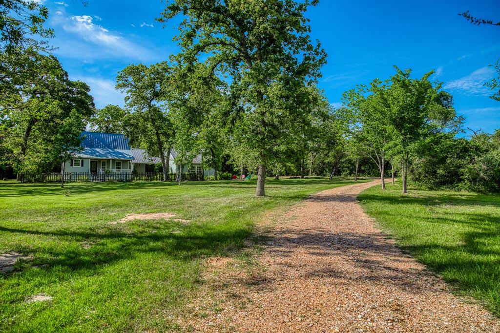 The gated entrance and rock driveway leading to your private retreat.