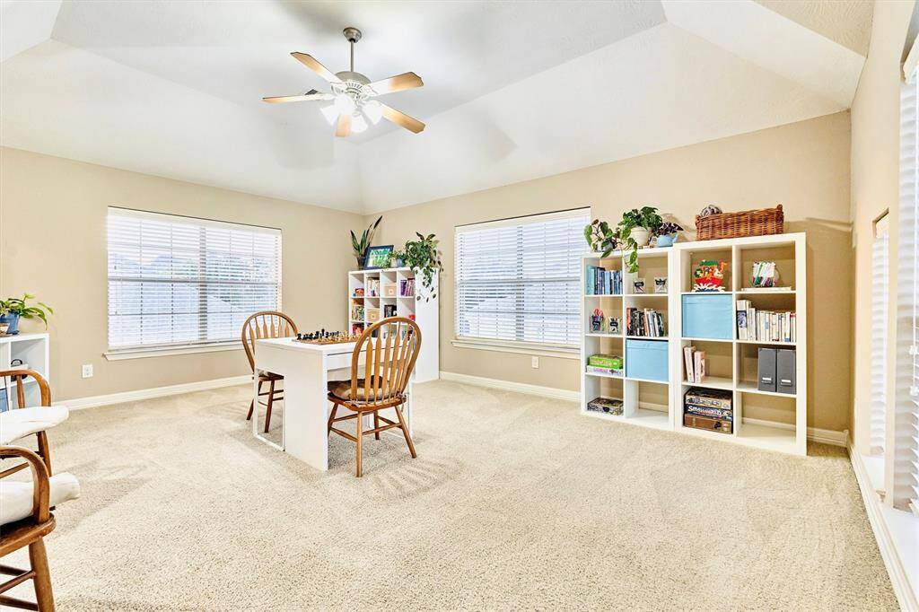Game room upstairs is tucked to the side and offers a set of secondary stairs that take you straight down to the kitchen