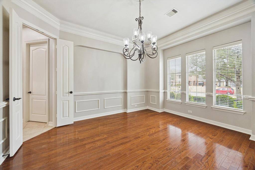 Formal dining room awaits you for all your holiday meals and special dinner nights. This dining room is complete with engineered wood floors, chair rail, wainscot molding, crown molding and an elegant chandelier.