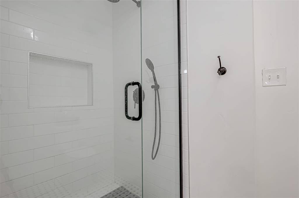 Luxurious en-suite bath with double vanities and a walk-in shower.