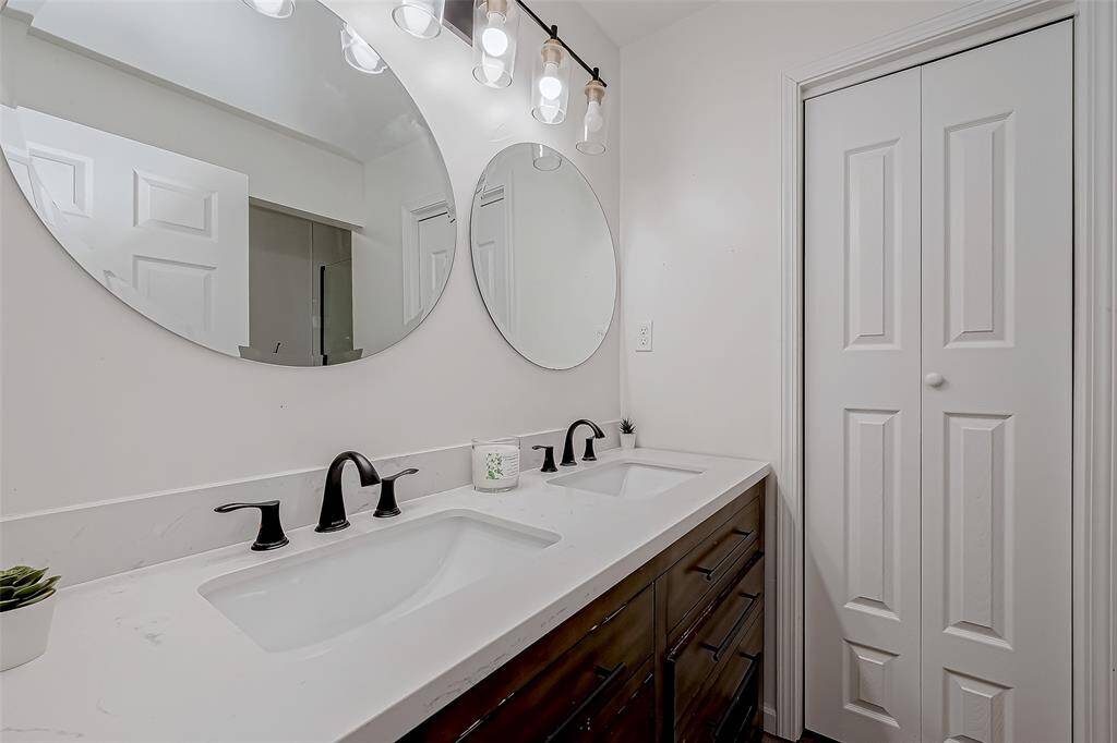 Luxurious en-suite bath with double vanities and a walk-in shower.