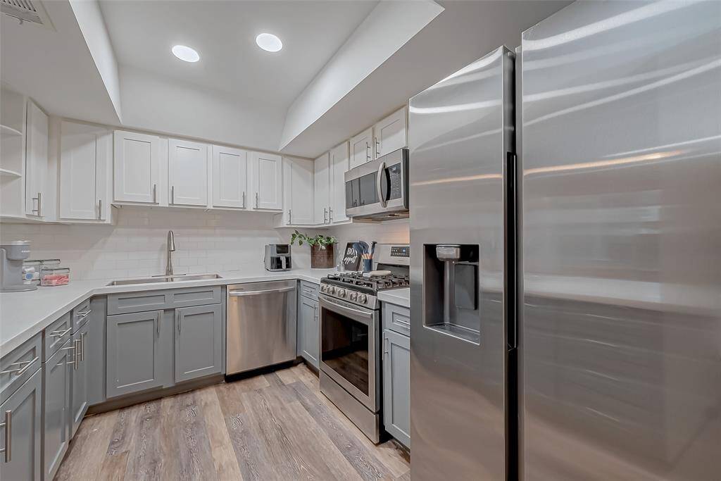 Beautifully updated kitchen with modern appliances, sleek countertops, and ample cabinet space.