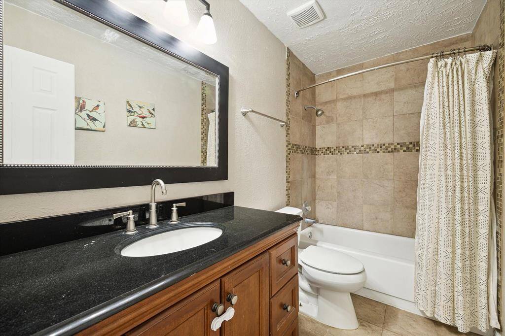 The secondary bedrooms share this bathroom with a shower/tub combo