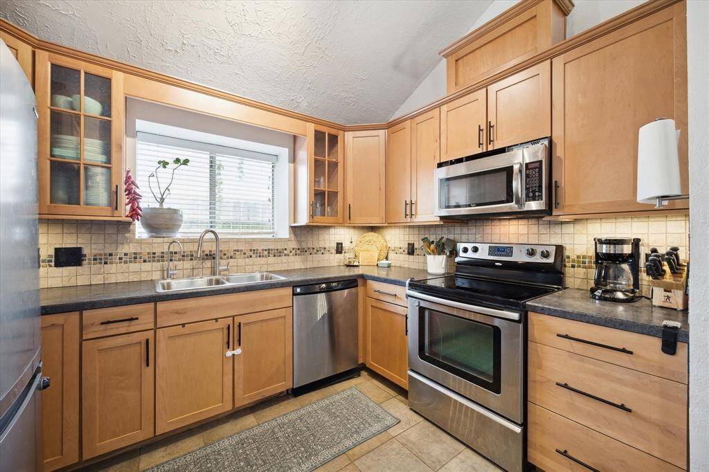The kitchen has been updated with new cabinets and counters