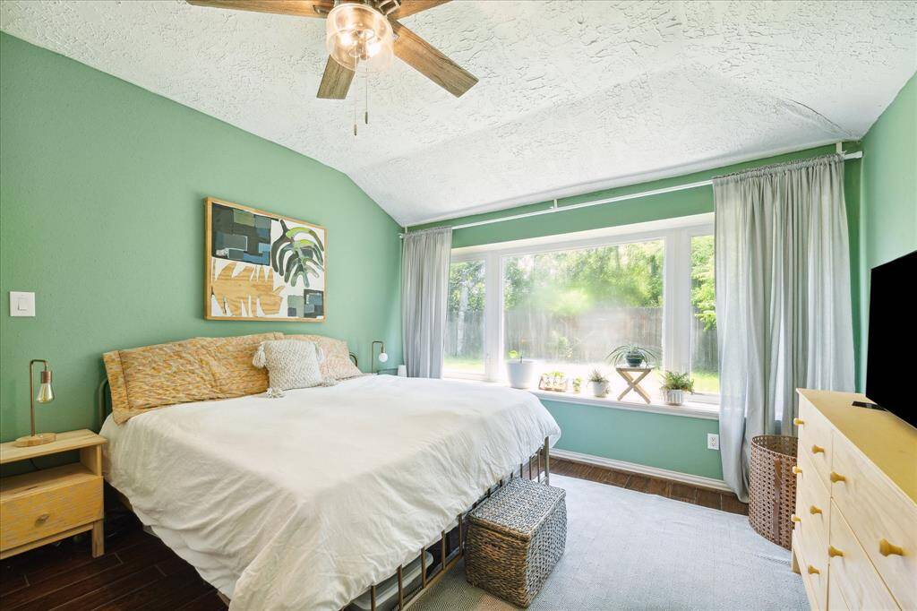 The primary bedroom boasts a large window that looks out to the backyard - plenty of room for a king-sized bed, nightstands, and dresser