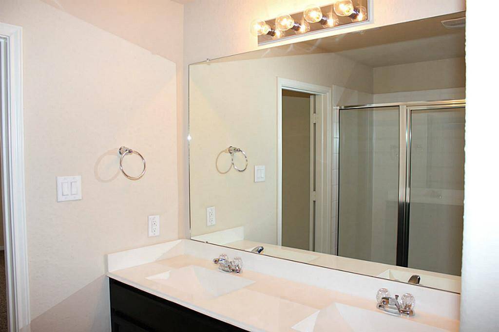Master bathroom with dual sinks and oversized shower