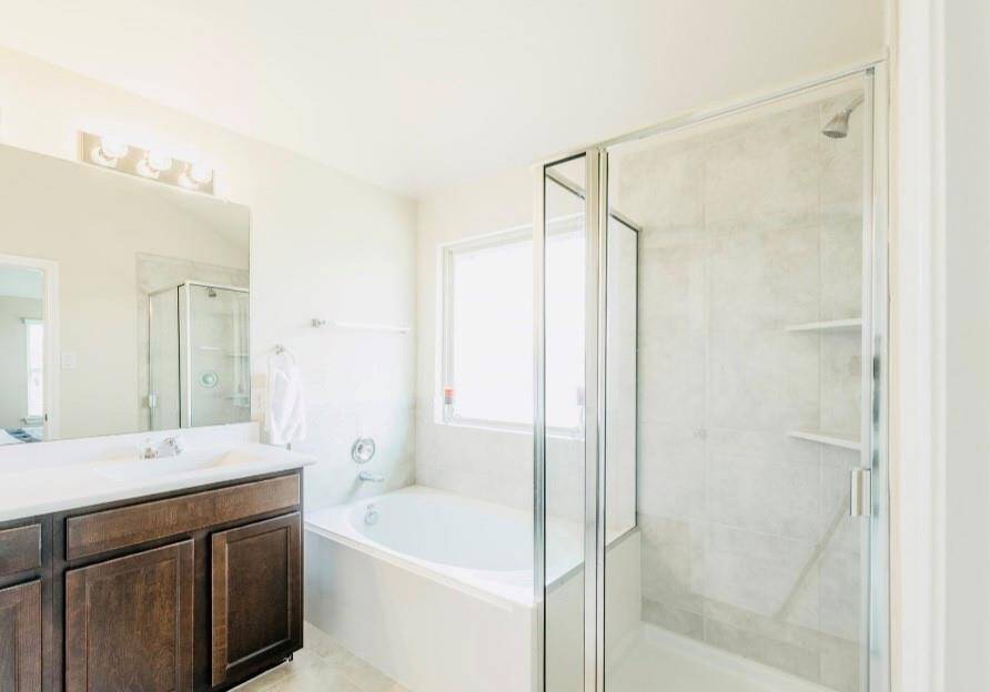 Primary bathroom has separate shower and tub.