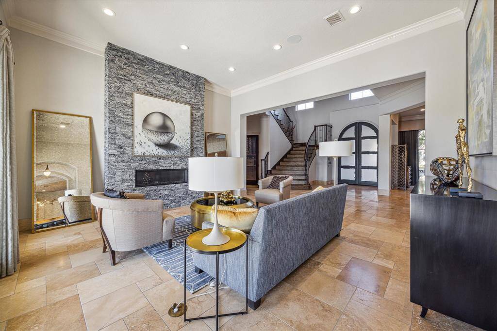 Formal living room open to the entry and overlooking the pool and golf course with waterviews.