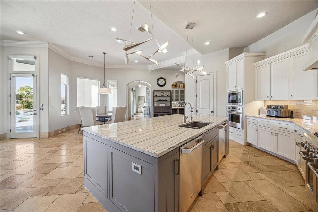 Another view of the kitchen and oversized island including two dishwashers