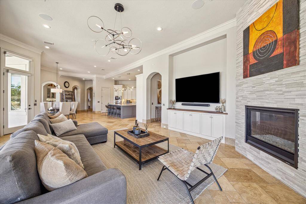 First floor family room open to the kitchen and breakfast room. Wall to wall exterior doors leading to the patio, outdoor pavilion and pool