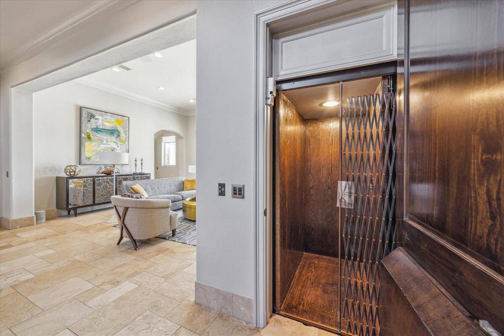 Elevator conveniently located off the entry, wood floors and paneled walls.