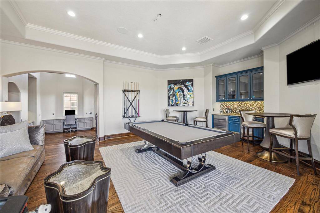 Second floor gameroom with balcony overlooking the pool and waterview on the golf course. Home Office area located across the hallway. Bar in gameroom complete with ice maker and undercounter refrigerator.