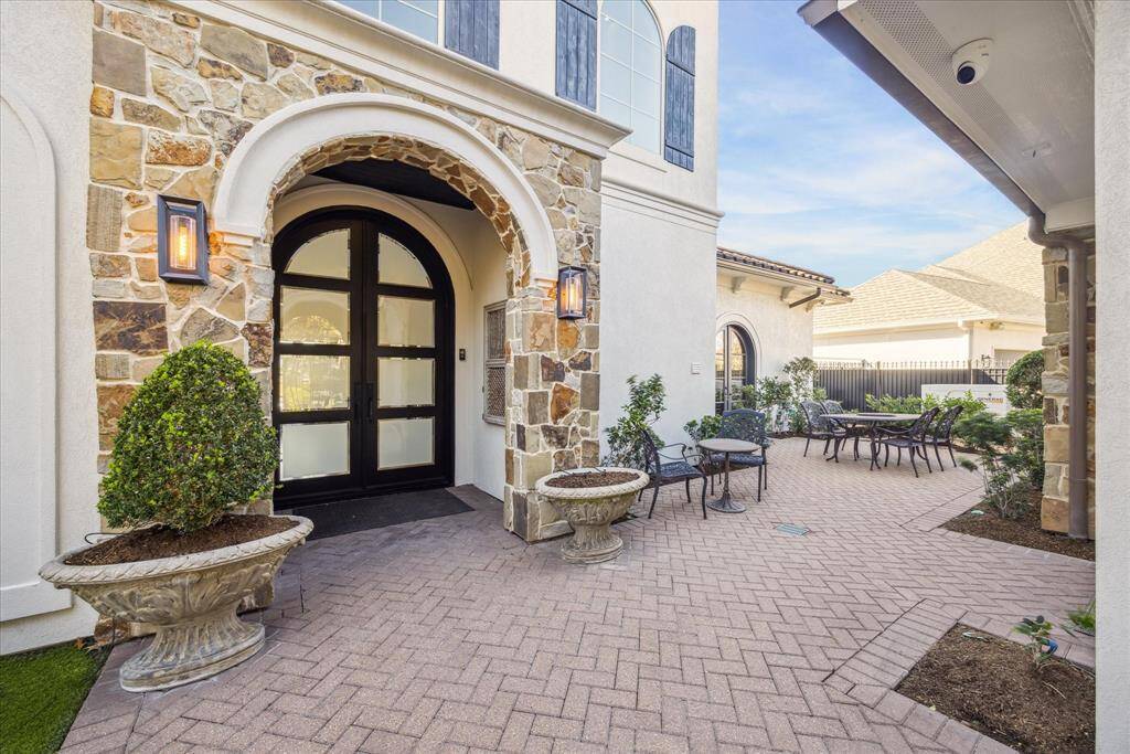 Gated front courtyard with fountain, sitting area outside the study and casita, and generator.