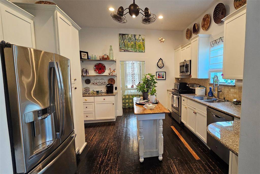 The Kitchen has been upgraded with Granite Countertops and Stainless-Steel appliances that stay with the home. Remote Control Fan with High Ceilings!