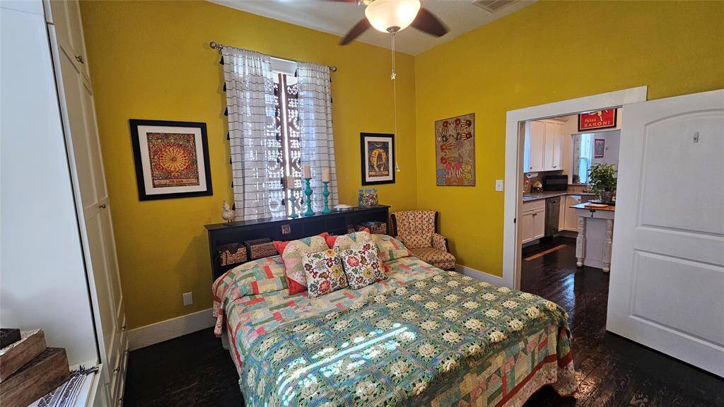 Primary Bedroom located by the Kitchen, High Ceilings and Hard Wood Floors!