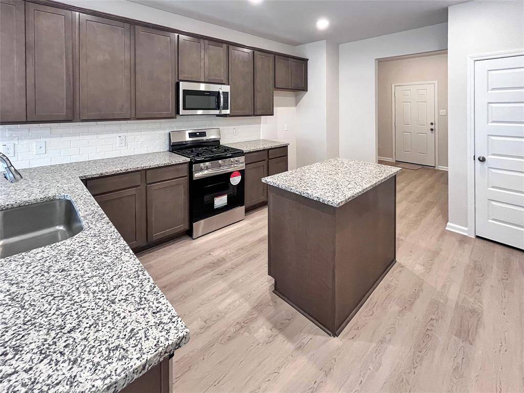 The Cardinal II- Kitchen with Optional Island. Home under construction. Sample floor plan photo used for illustrative purposes only. Upgrades, selections options, windows and colors may vary.