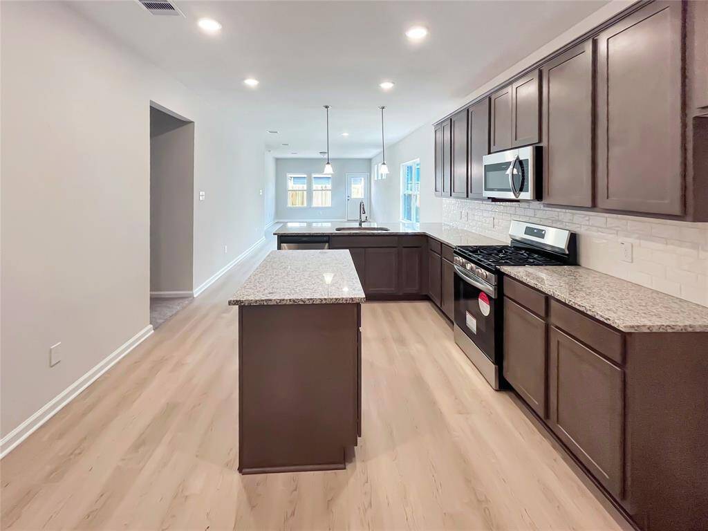 The Cardinal II- Kitchen with Optional Island. Home under construction. Sample floor plan photo used for illustrative purposes only. Upgrades, selections options, windows and colors may vary.