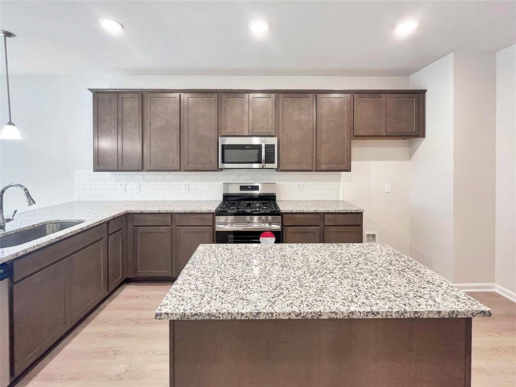 The Cardinal II- Kitchen with Optional Island. Home under construction. Sample floor plan photo used for illustrative purposes only. Upgrades, selections options, windows and colors may vary.
