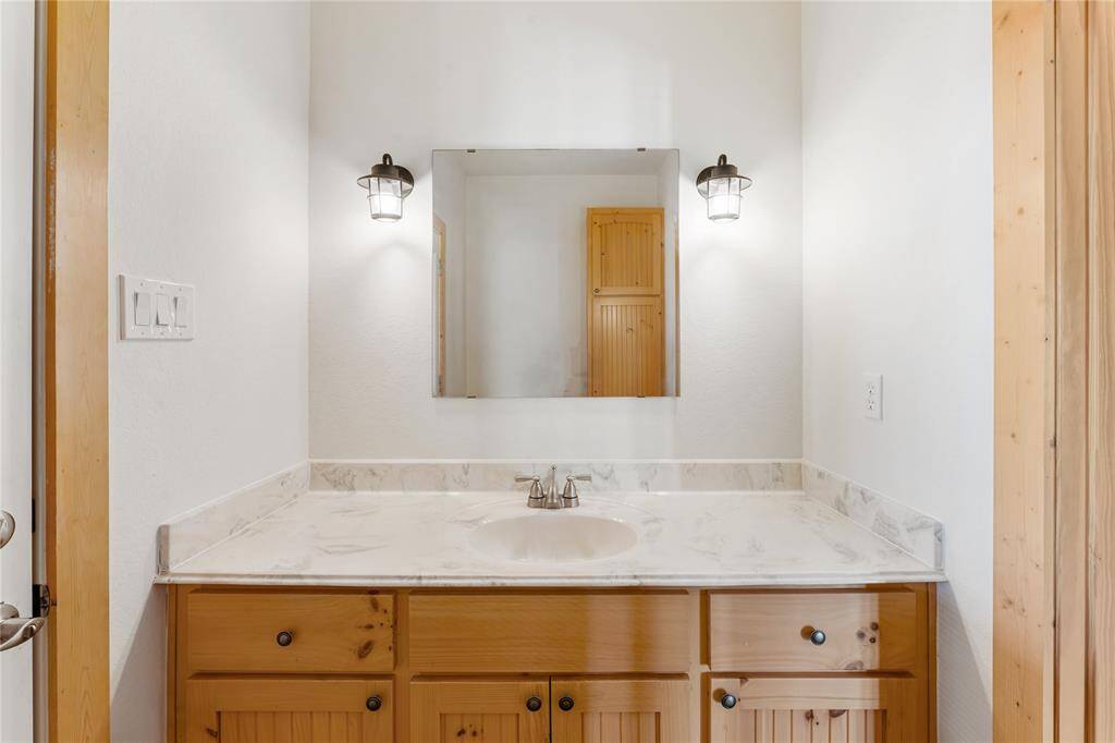 Utility room with built-in shelving, water tank and whole home water purification system.
