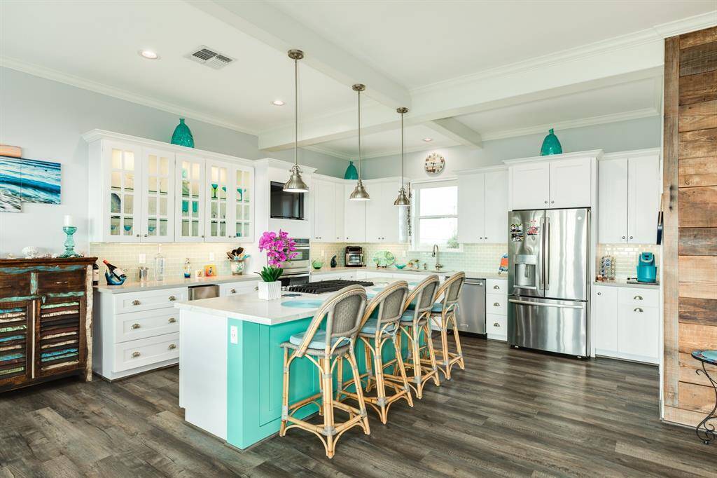 Kitchen view. Beautiful large island with gas cooktop & plenty of seating and storage below.