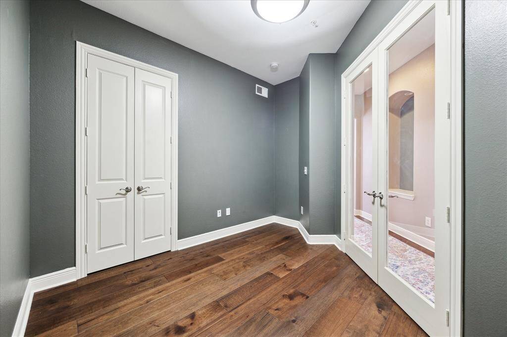 The dedicated office offers versatility as a home workspace, nursery, or third bedroom, complete with a closet and elegant glass French doors.