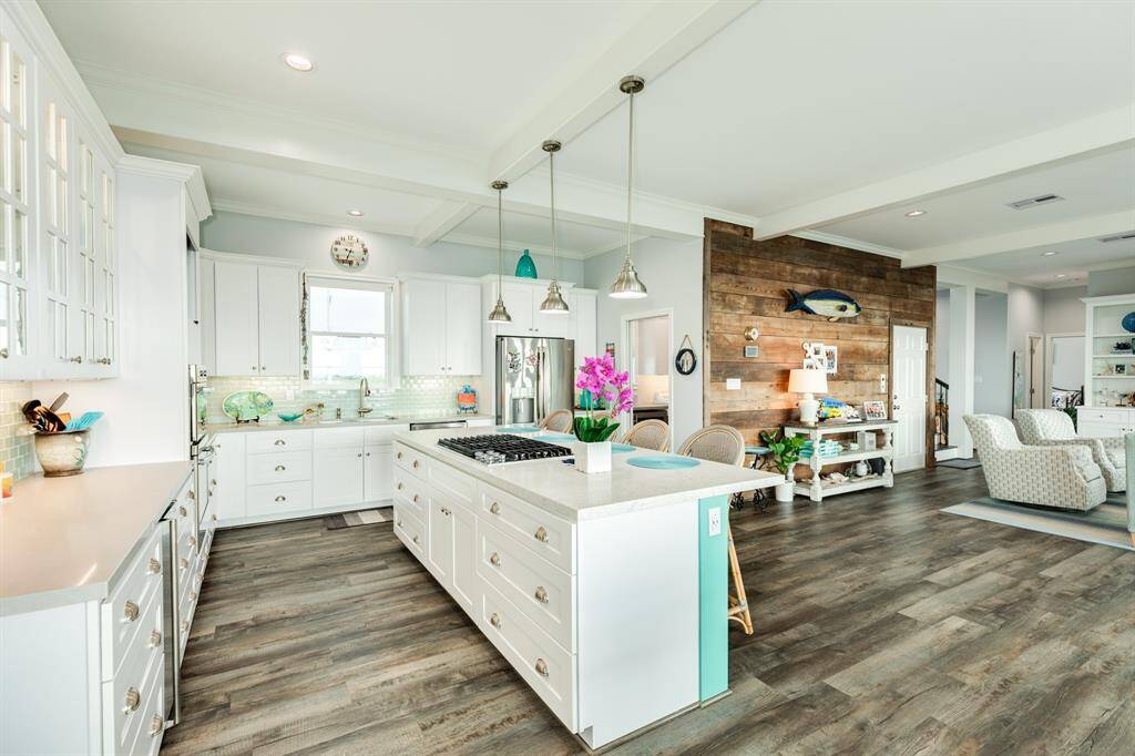 Another kitchen view. Stainless appliances including an ice maker, Fridge/Freezer, Dishwasher, Oven & Microwave. Beverage refrigerator located in walkin pantry/utility room.